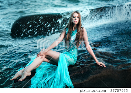 Woman posing on a beach with rocks Woman posing on a beach with rocks 27707955