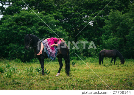 Beautiful woman on a horse 27708144