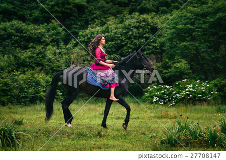 Beautiful woman on a horse 27708147