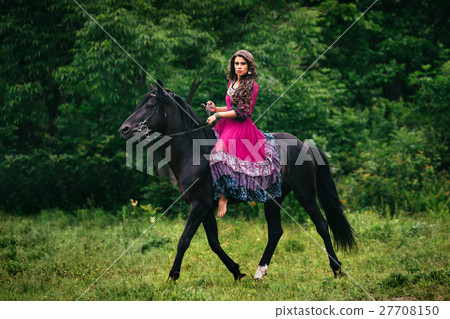 Beautiful woman on a horse 27708150