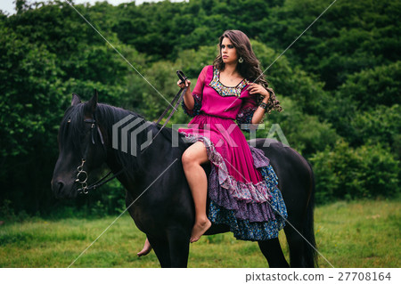 Beautiful woman on a horse 27708164