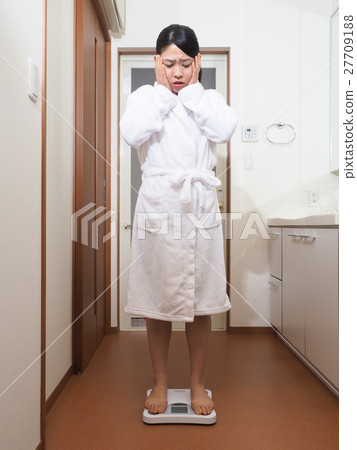 一個女人驚訝地測量他的體重 27709188