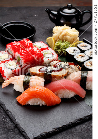 Sushi set on a stone plate and concrete background 27711551
