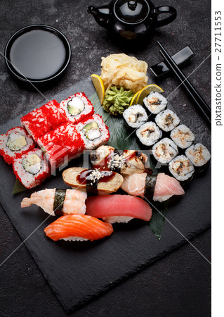 Sushi set on a stone plate and concrete background 27711553