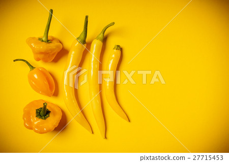 small peppers on a yellow background small peppers on a yellow background 27715453