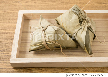Zongzi or Sticky Rice Dumpling on A Wooden Tray Zongzi or Sticky Rice Dumpling on A Wooden Tray 27715773