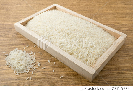 Uncooked Jasmine Rice in A Wooden Tray Uncooked Jasmine Rice in A Wooden Tray 27715774