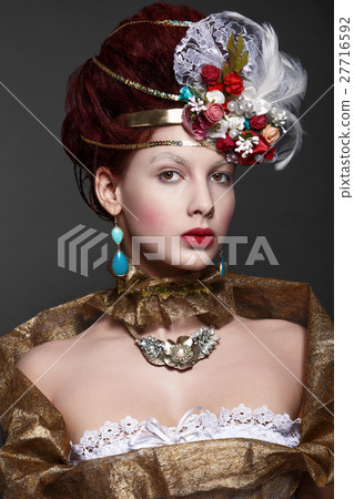 Young girl in baroque gold attire. Historical look 27716592