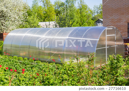 Greenhouse made of polycarbonate in the garden 27716610