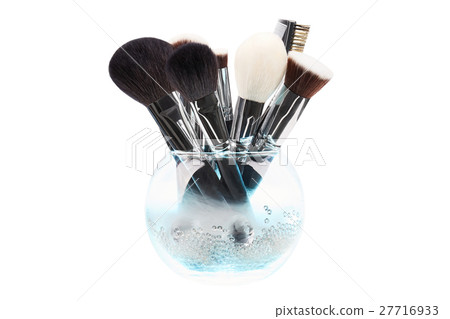 Makeup brushes in glass vase. Crystals. Blue smoke 27716933