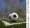 Soccer ball on the green field 27717764