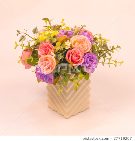 Vintage artificial rose flower in vase on white  27719207