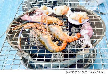 Grilling seafood on blue painted wooden table Grilling seafood on blue painted wooden table 27724476