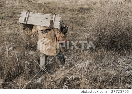 boy carries a wooden box boy carries a wooden box 27725705
