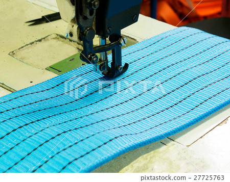 Industrial sewing machine sews a ratchet strap Industrial sewing machine sews a ratchet strap 27725763