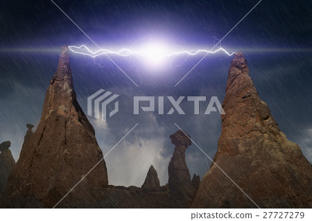 Lightning discharges between peaks of two rocks 27727279