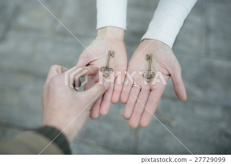 Male and female hands handling the key 27729099