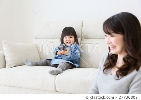 Infant using a smartphone Infant using a smartphone 27730802