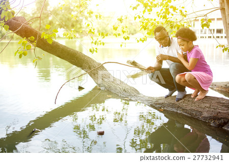 African American family playing around the lake African American family playing around the lake 27732941