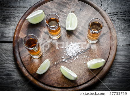 Glasses of tequila on the wooden board 27733739