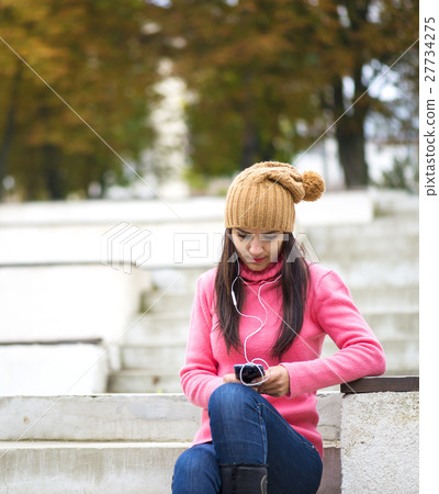 Pretty girl listening music with her headphones 27734275