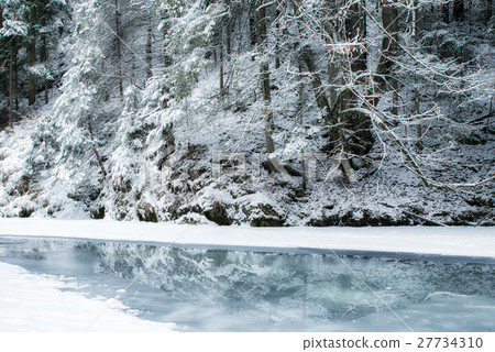 Frozen river in winter forest Frozen river in winter forest 27734310
