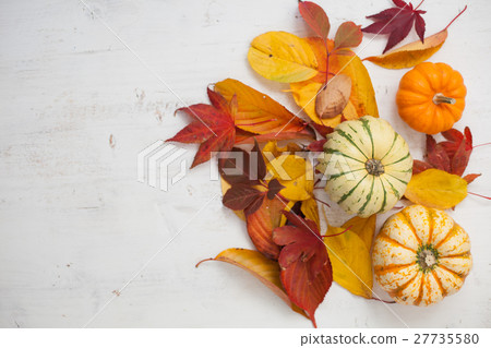 Three gourds on the grey table, autumn leaves 27735580