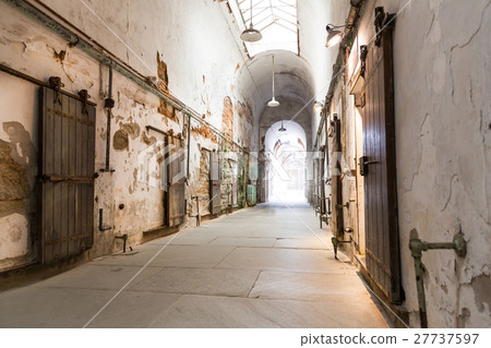 Jail hallway with locked doors. 27737597