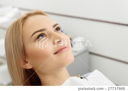 Dreamy eyes and cute smile of woman at stomatology 27737988