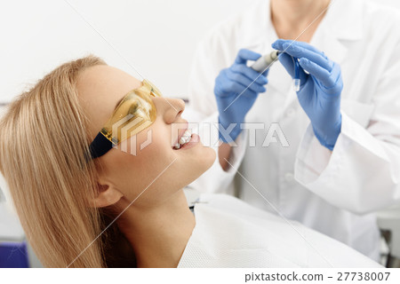 Dental professional giving female mecical 27738007