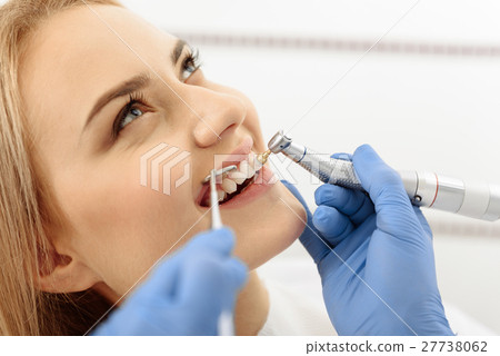 Attractive smiling woman creating teeth whitening 27738062