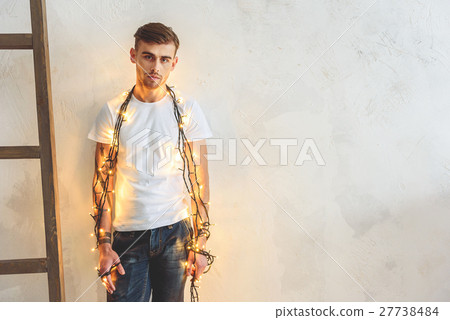 Sad guy holding Christmas tree decoration 27738484