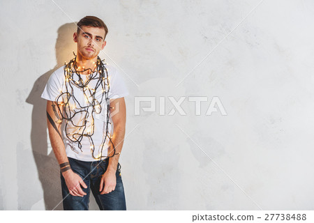 Guy with garland is tired from holidays 27738488