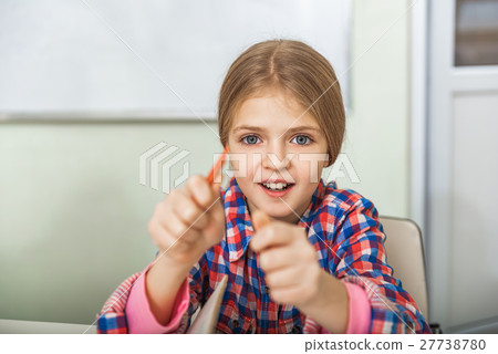 Interested female pupil in classroom 27738780