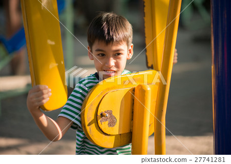 Little boy riding power gym bicycle at playground Little boy riding power gym bicycle at playground 27741281