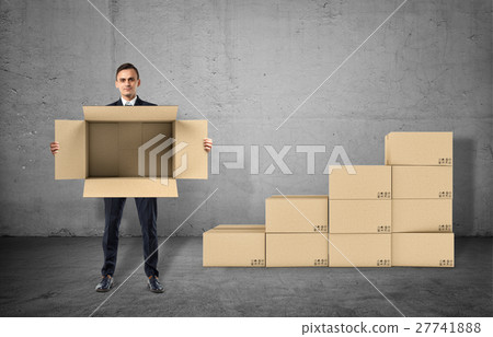 Businessman is showing an open box in his hands Businessman is showing an open box in his hands 27741888