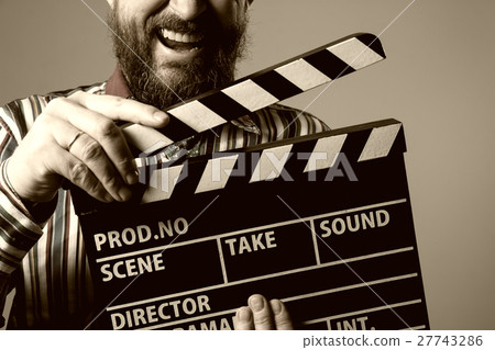 Close-up of a man smiling clapperboard cinema Close-up of a man smiling clapperboard cinema 27743286