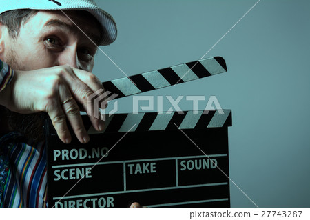 Close-up of a man smiling clapperboard cinema Close-up of a man smiling clapperboard cinema 27743287