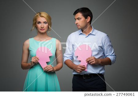 Beautiful couple holding pink broken heart 27749061