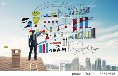 Rear view of businessman on house roof drawing his new business Rear view of businessman on house roof drawing his new business 27757656