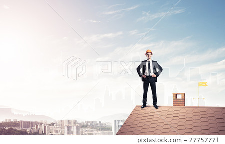 Engineer man standing on roof and looking away. Mixed media Engineer man standing on roof and looking away. Mixed media 27757771