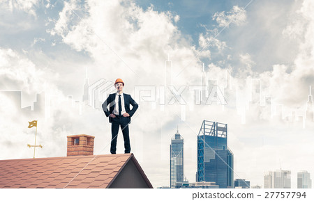 Engineer man standing on roof and looking away. Mixed media Engineer man standing on roof and looking away. Mixed media 27757794