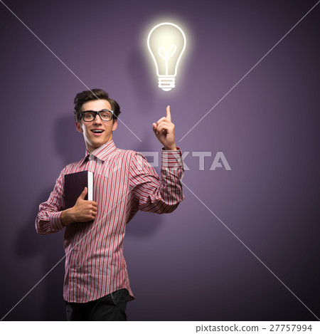 young man holding a book young man holding a book 27757994