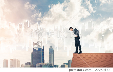 Businessman looking down from roof and modern cityscape at backg Businessman looking down from roof and modern cityscape at backg 27759158