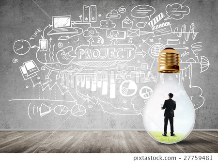 Businessman trapped in bulb Businessman trapped in bulb 27759481