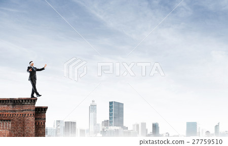 Danger and risk concept with businessman making step from edge 27759510