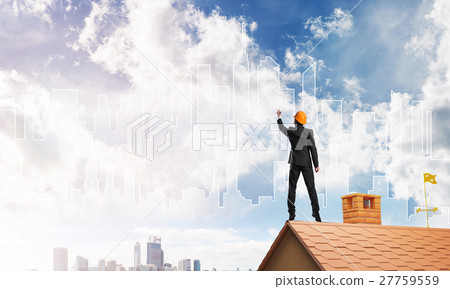 Man architect draw silhouette of modern city on blue sky. Mixed media 27759559