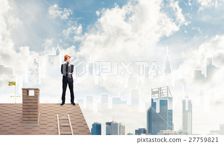 Engineer man standing on roof and looking away. Mixed media 27759821