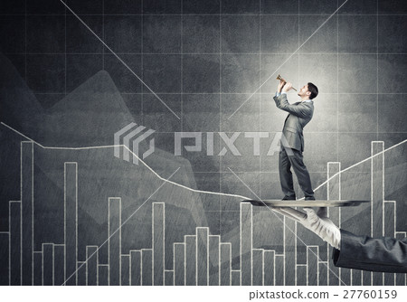 Young businessman on metal tray playing fife against concrete background with chart Young businessman on metal tray playing fife against concrete background with chart 27760159