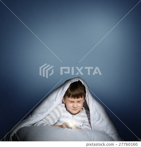 boy under the covers with a flashlight boy under the covers with a flashlight 27760160